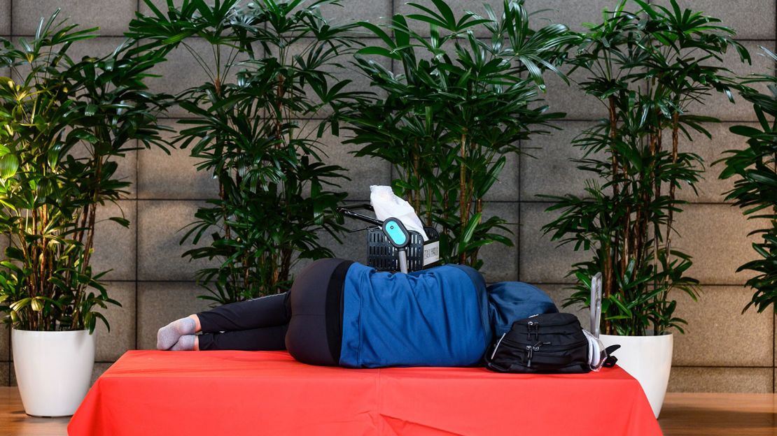 Someone catches some rest in the departure hall of Tokyo's Haneda Airport in March 2020.