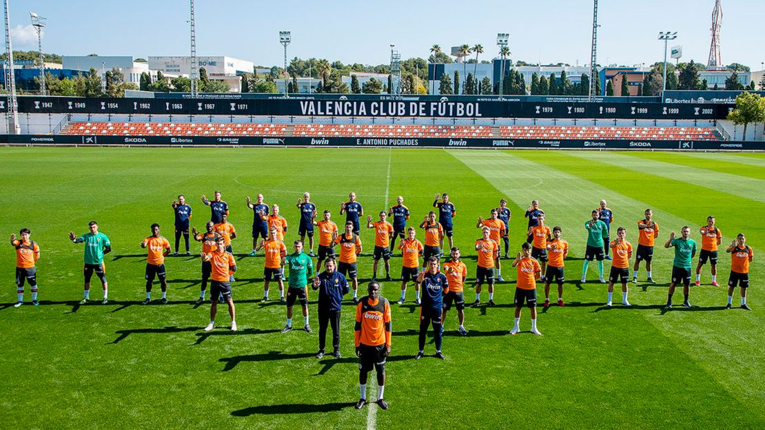 Valencia's squad stands in solidarity at training on Monday.