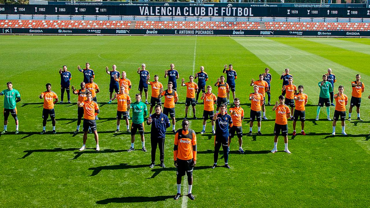 Valencia's squad stands in solidarity at training on Monday.