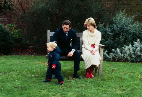 Prince William takes his first steps in public with his parents in the walled garden at Kensington Palace on December 14, 1983.
