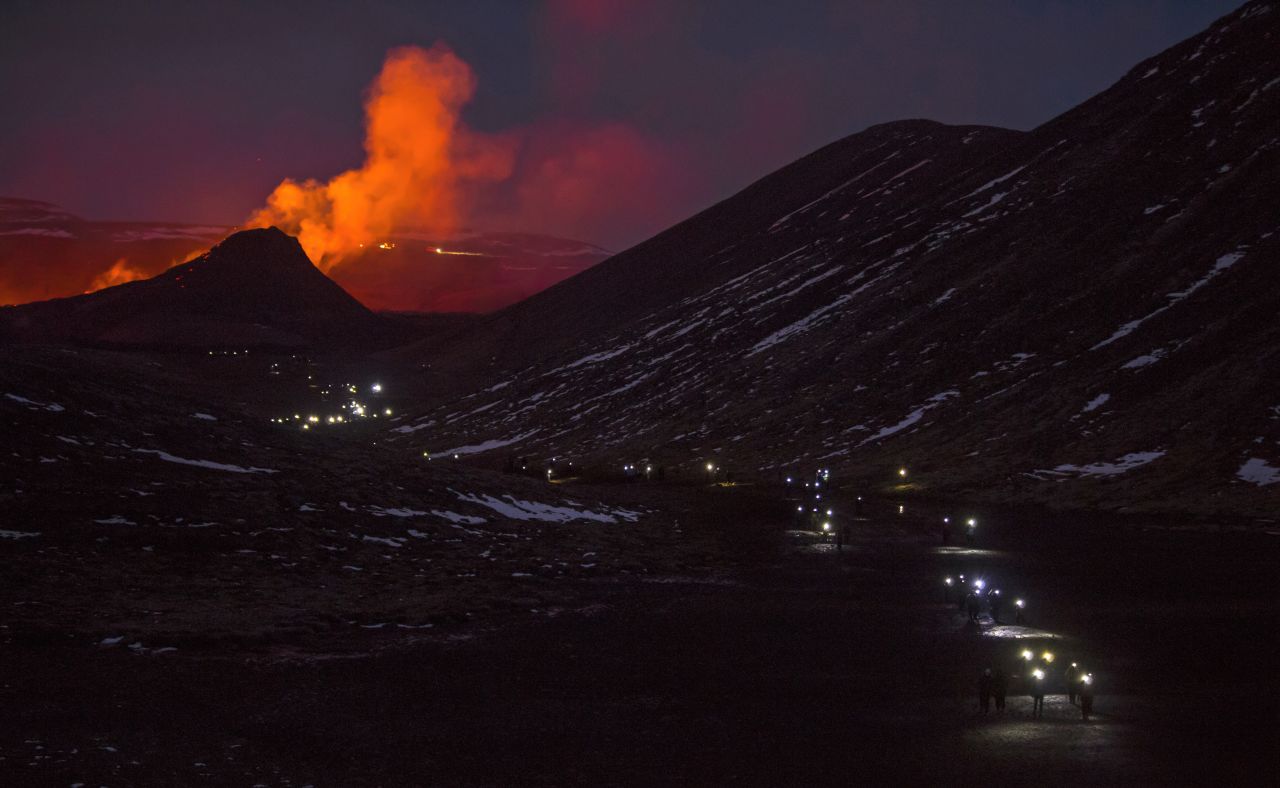 People's flashlights can be seen as they leave the site of the volcano on March 31. Crowds of people have been flocking to the site to witness the lava flows.
