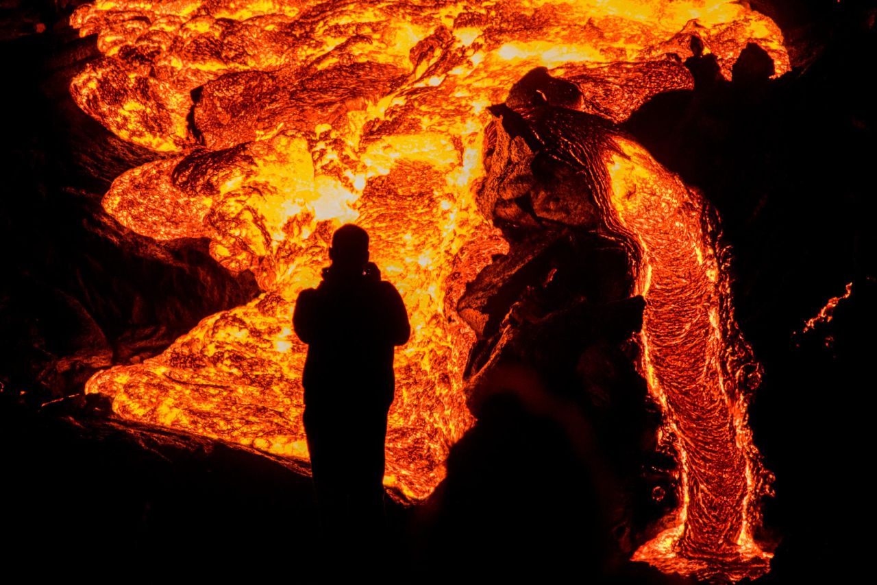 A person watches the volcano on March 29.