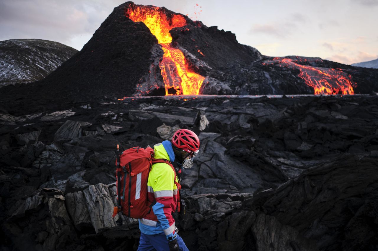 A hiker walks past the volcano on March 26.