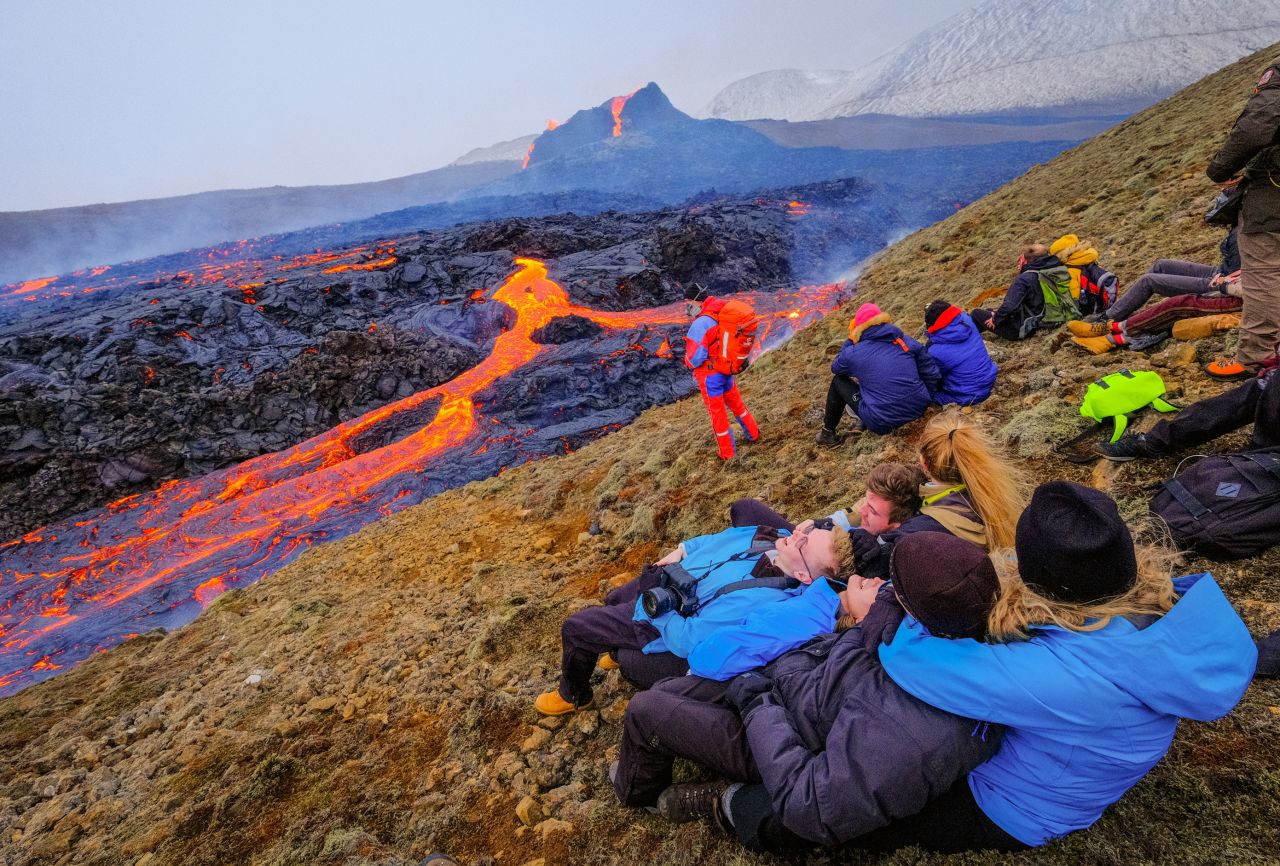 People relax and observe the volcano on March 25.