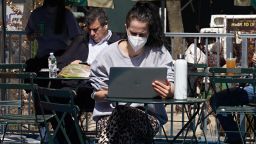 NEW YORK, NEW YORK - MARCH 23: A person wearing a protective mask uses a laptop computer in Bryant Park on March 23, 2021 in New York City. After undergoing various shutdown orders for the past 12 months the city is currently in phase 4 of its reopening plan, allowing for the reopening of low-risk outdoor activities, movie and television productions, indoor dining as well as the opening of movie theaters, all with capacity restrictions. (Photo by Cindy Ord/Getty Images)