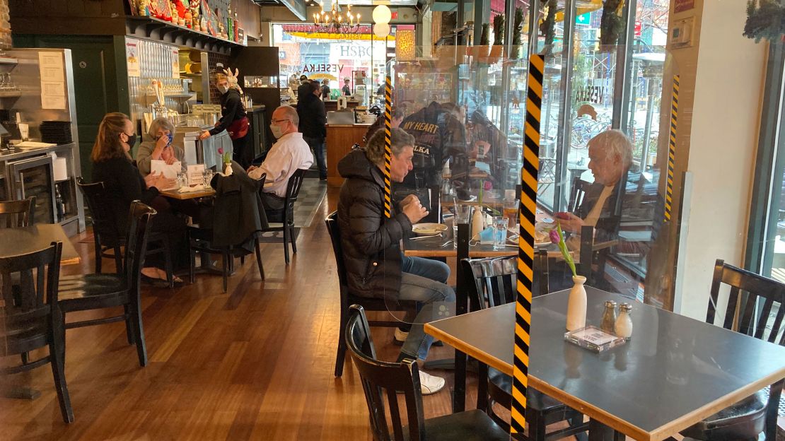 Above, people eat indoors as indoor dining continues to open up in New York City on March 24. Physical distancing, barriers and good ventilation are a few ways to reduce Covid-19 risk.
