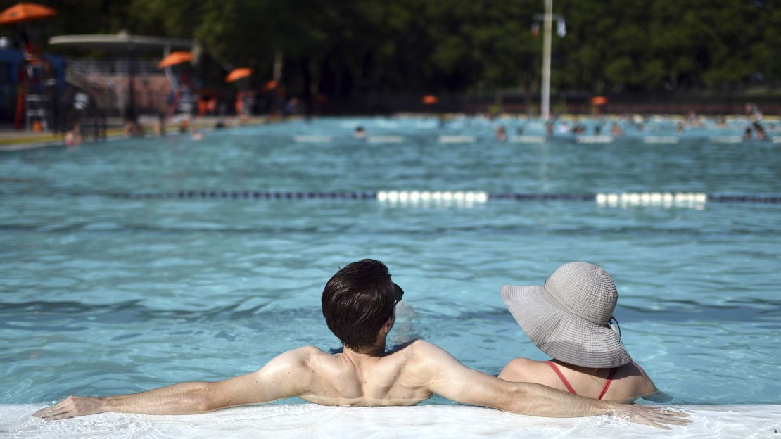 Two bathers sit in the Astoria Park outdoor pool in New York City on August 1, 2020. 