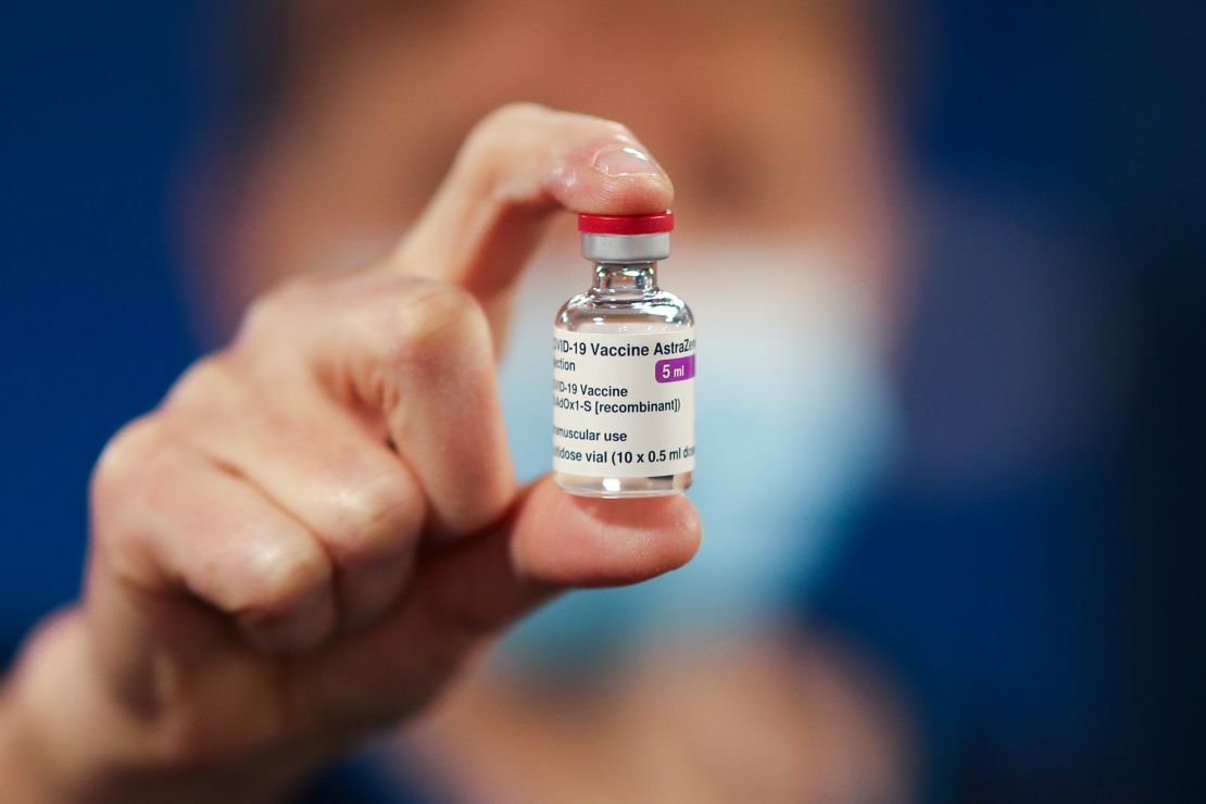 A healthcare worker holds a vial of the AstraZeneca vaccine in Scotland. More than 20 million doses have been given out in the UK.