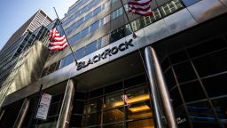 Pedestrians wearing protective masks walk past BlackRock Inc. headquarters in New York, U.S, on on Thursday, July 9, 2020. BlackRock is scheduled to release earnings figures on July 17.