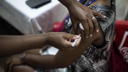 A woman, a member of the Kenyatta National Hospital health staff, is vaccinated within the same hospital's vaccination program, which began at the beginning of March. In Nairobi, Kenya, on March 24, 2021.  (Photo by Robert Bonet/NurPhoto via Getty Images)