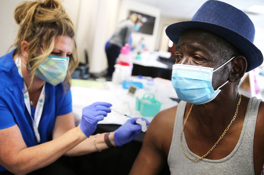 Larry Green receives a Band-Aid from registered nurse Teresa Frey after he received his second dose of the Moderna Covid-19 vaccine at Lincoln Memorial Congregational Church UCC last month in Los Angeles.
