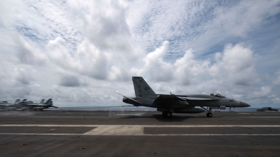A US Navy F/A-18E Super Hornet lands on the flight deck of the aircraft carrier USS Theodore Roosevelt on April 5, 2021, during operations in the South China Sea. 