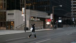 A pedestrian walks across Wellington Street West in the financial district of Toronto, Ontario, Canada, on Thursday, March 25, 2021. Premier Doug Ford said further lockdowns could happen as a government agency that tracks hospitalizations reported the biggest single-day jump in admissions of patients to intensive care since the pandemic began, CBC reports. Photographer: Galit Rodan/Bloomberg via Getty Images