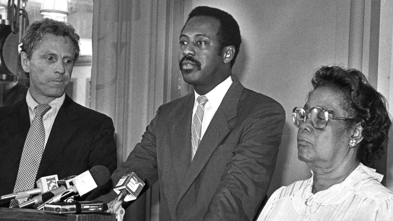 A federal court jury in Mobile, Ala., awarded Beulah May Donald $7 million in damages from the United Klans of America Inc., Feb. 12, 1987. Two Klan members murdered Mrs. Donald's son, Michael Donald, 19, in 1981. Mrs. Donald is shown at a news conference after the verdict with her attorneys, State Sen. Michael Figures, center at podium, and Morris Dees, founder of the Southern Poverty Law Center in Montgomery. (AP Photo/Mobile Press-Register/Mary Hattler)