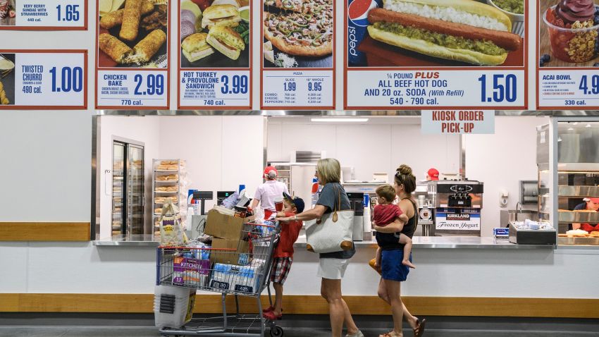 Jaxon Stern, 4, from left, Nicole Toone, Sawyer Stern, 2, and Victoria Stern order lunch at Costco's food court while shopping in the new Evansville store, Friday, June 28, 2019. They ordered a few "famous" $1.50 hot dogs. Costco Opening 18