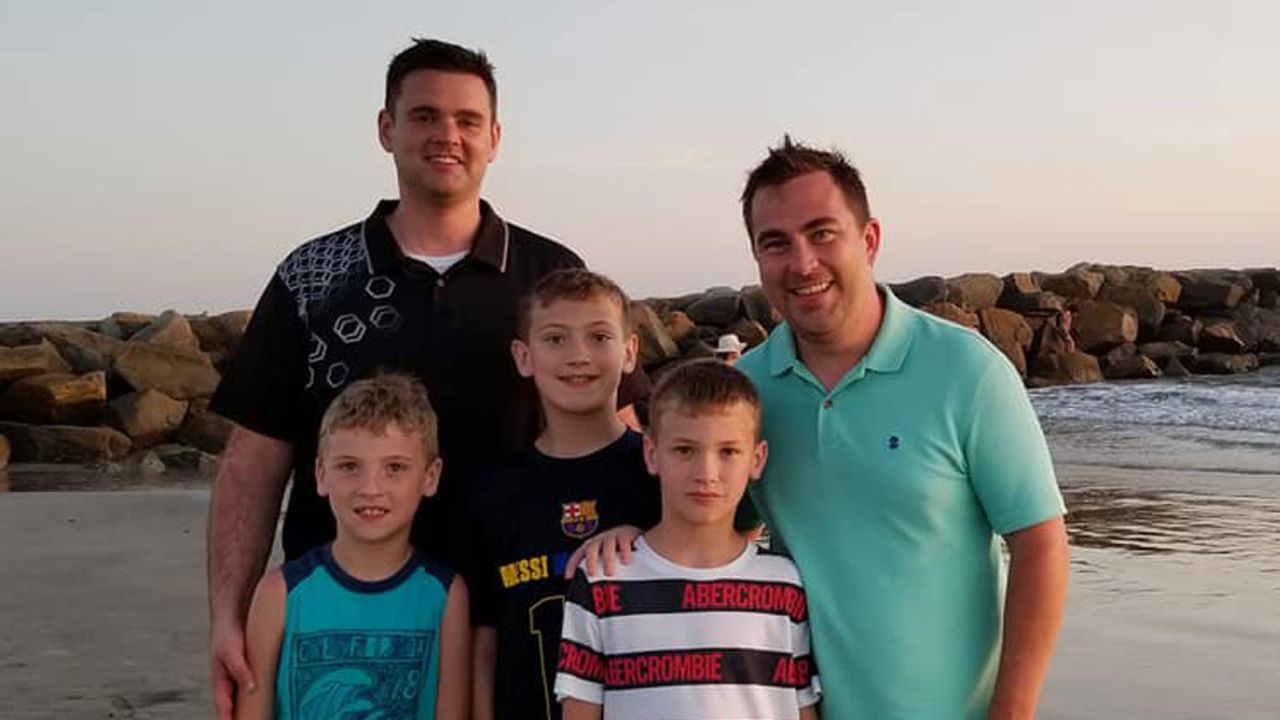 John Reynolds and his partner John McClanah with their three children.
