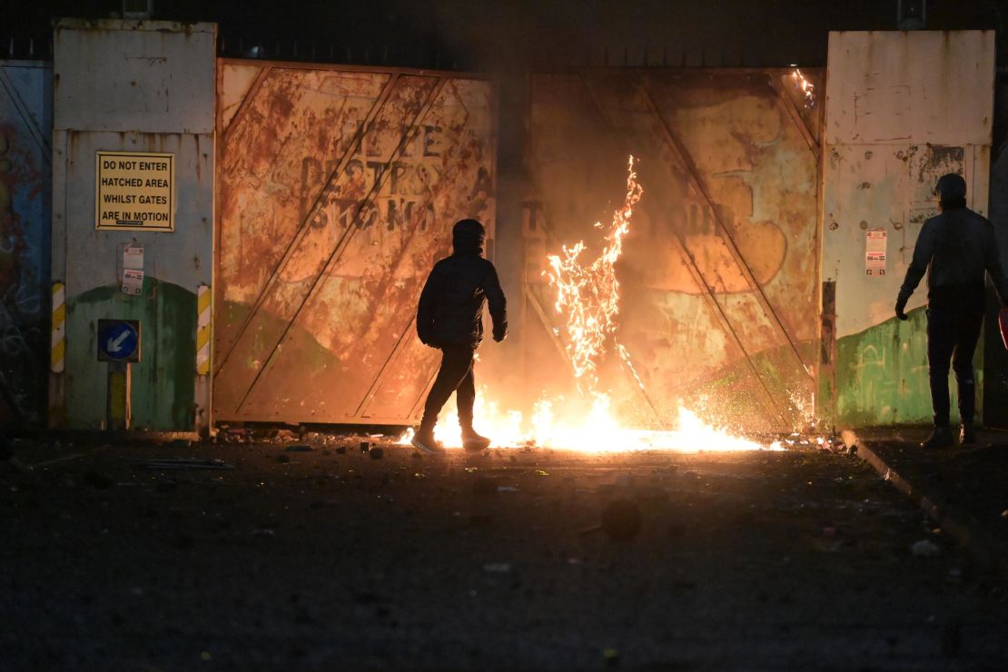 Fire fed by petrol burns as youths clashed at the Peace Gate at the Springfield Road/Lanark Way interface on April 7 in Belfast, Northern Ireland. 