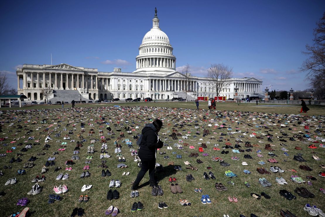 Pairs of shoes, representing the children killed by gun violence since the mass shooting at Sandy Hook Elementary School in 2012, are spread out on the Capitol lawn, in March 2018.