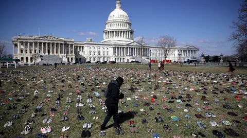 Pairs of shoes, representing the children killed by gun violence since the mass shooting at Sandy Hook Elementary School in 2012, are spread out on the Capitol lawn, in March 2018.