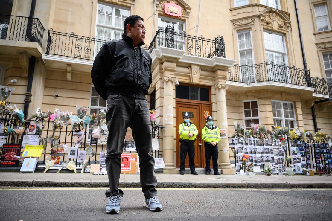 Kyaw Zwar Minn listens to a statement being read on his behalf as he stands outside the Myanmar embassy in London on Thursday.