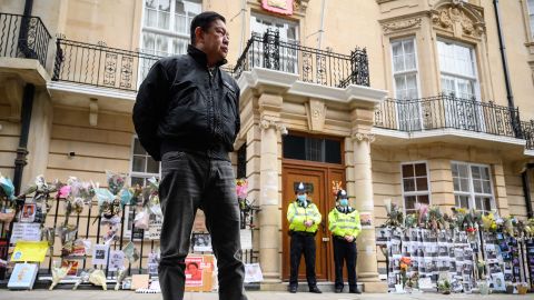 Kyaw Zwar Minn listens to a statement being read on his behalf as he stands outside the Myanmar embassy in London on Thursday.