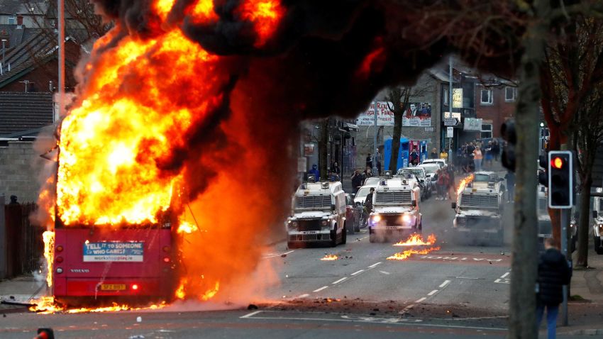 Police vehicles are seen behind a hijacked bus burns on the Shankill Road as protests continue in Belfast, Northern Ireland, April 7, 2021. REUTERS/Jason Cairnduff     TPX IMAGES OF THE DAY