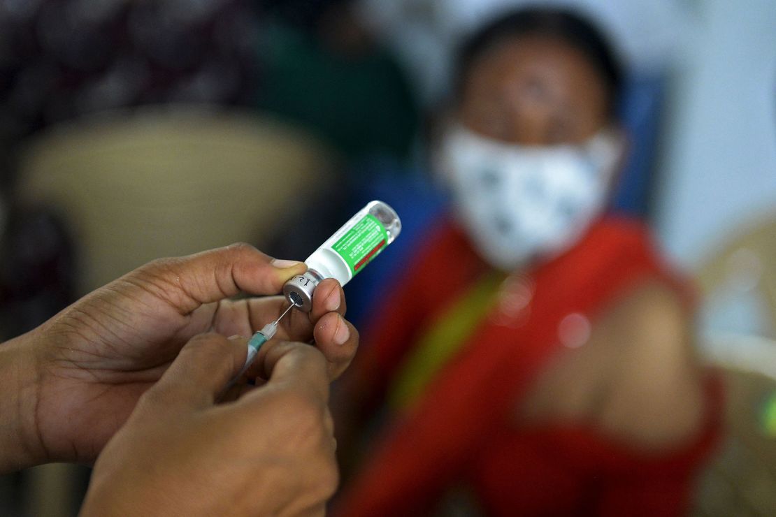 A medical worker prepares to innoculate a woman with a dose of AstraZeneca's vaccine in Hyderabad on Apr. 5.