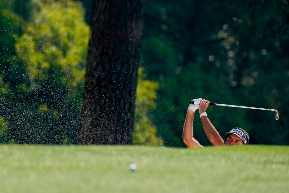 Two-time Masters champ Bubba Watson hits out of a bunker on the first hole Thursday.