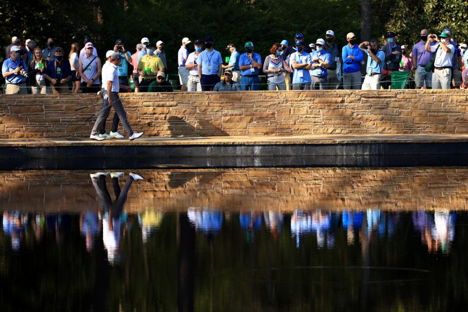 McIlroy and Thomas walk across the Sarazen Bridge during a practice round on Tuesday.