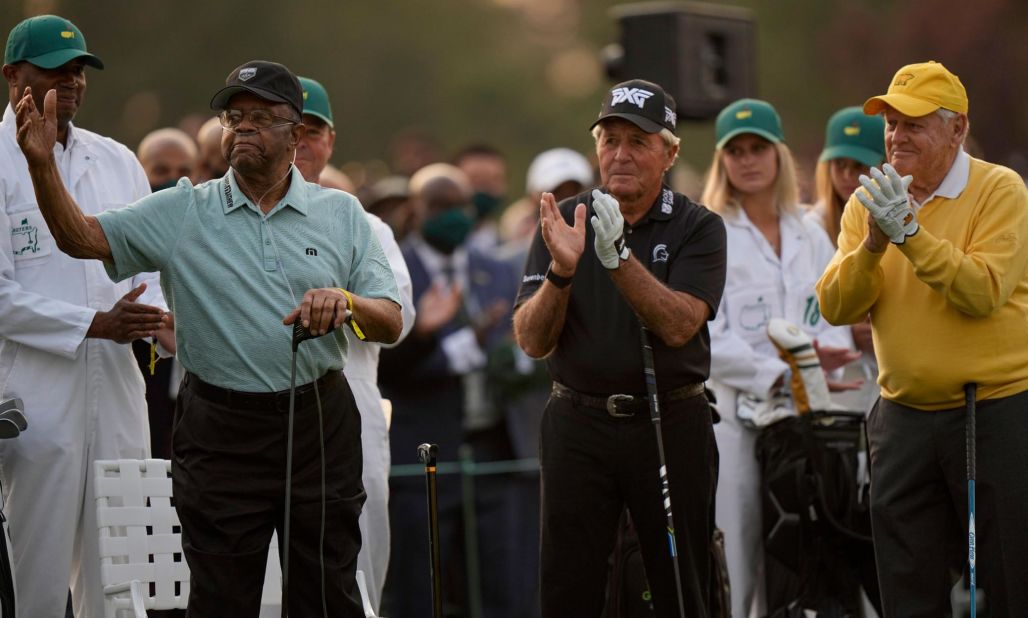Lee Elder acknowledges applause as he joins Gary Player and Jack Nicklaus as honorary starters on Thursday. In 1975, Elder became the first African American to play in the Masters.