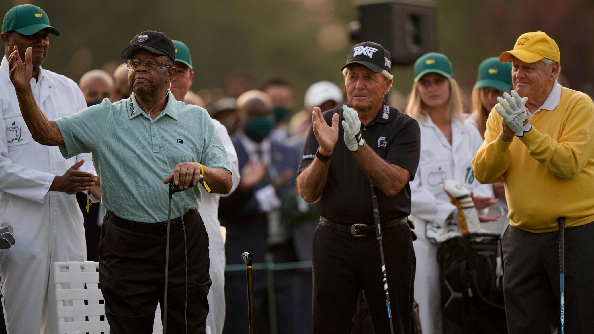 Lee Elder acknowledges applause as he joins Gary Player and Jack Nicklaus as honorary starters on Thursday. In 1975, Elder became the first African American to play in the Masters.