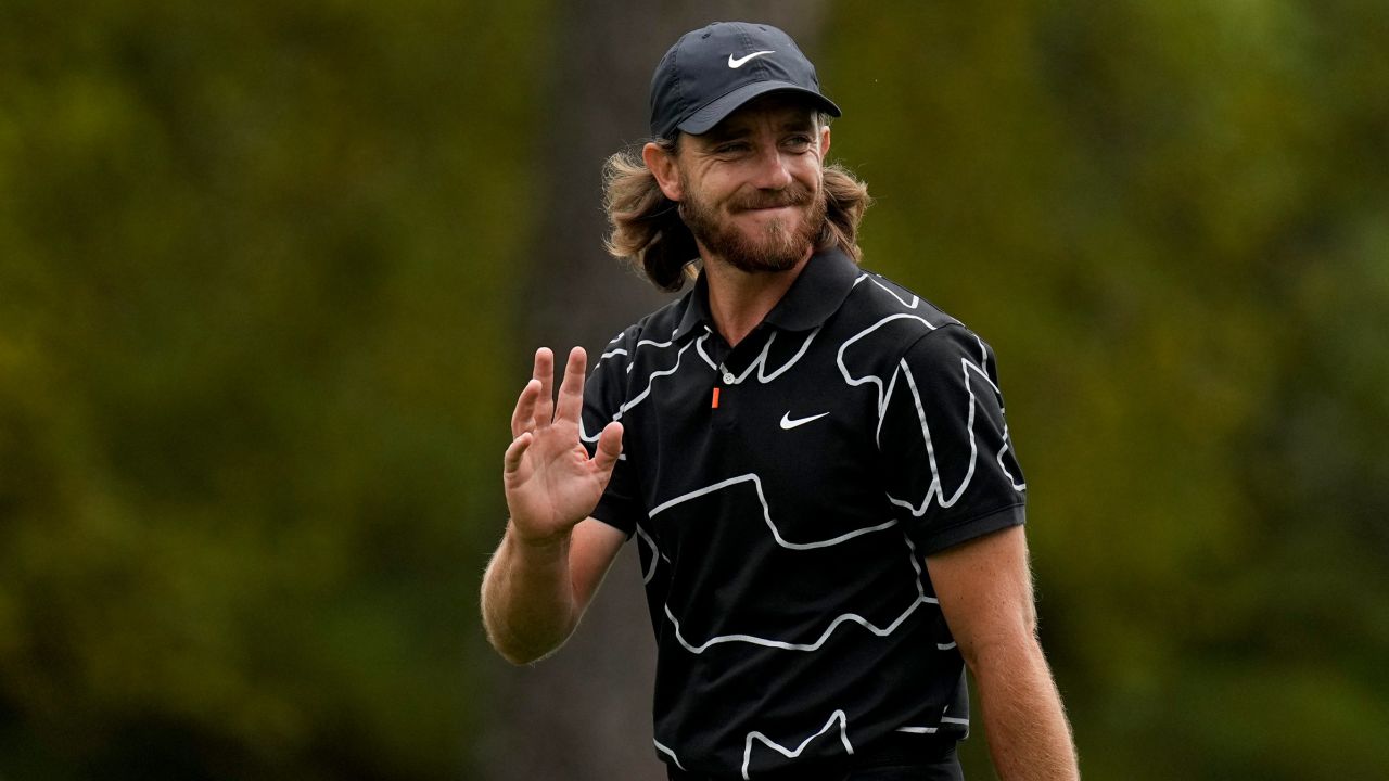 Tommy Fleetwood waves to the gallery as he walks up the first fairway during the first round of the Masters.