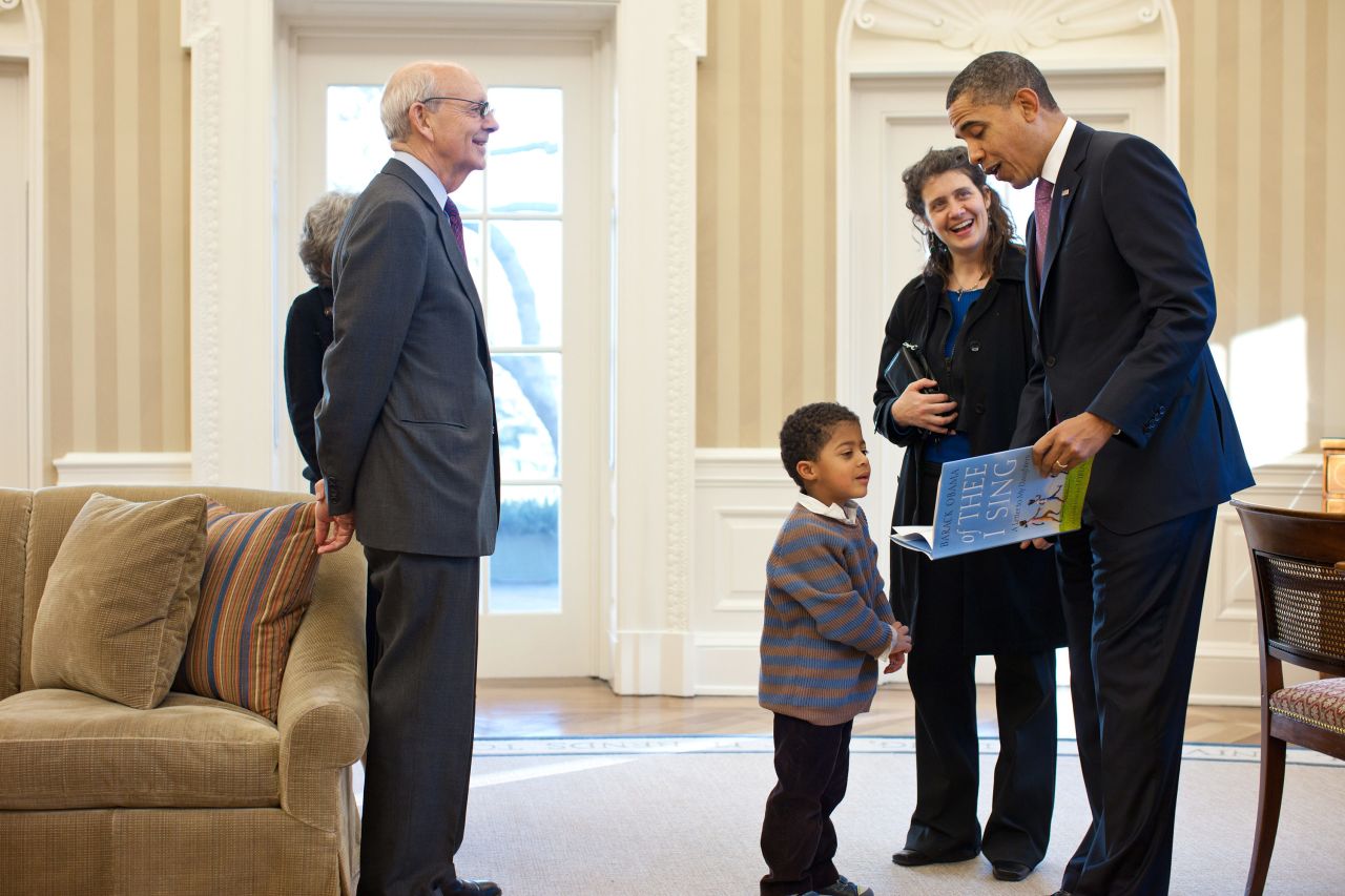 President Barack Obama reads from his book, "Of Thee I Sing: A Letter to My Daughters," as Breyer and some of his family members visit the White House Oval Office in May 2011. Joining Breyer, from left, are his wife, Joanna; his grandson Eli; and his daughter Nell.