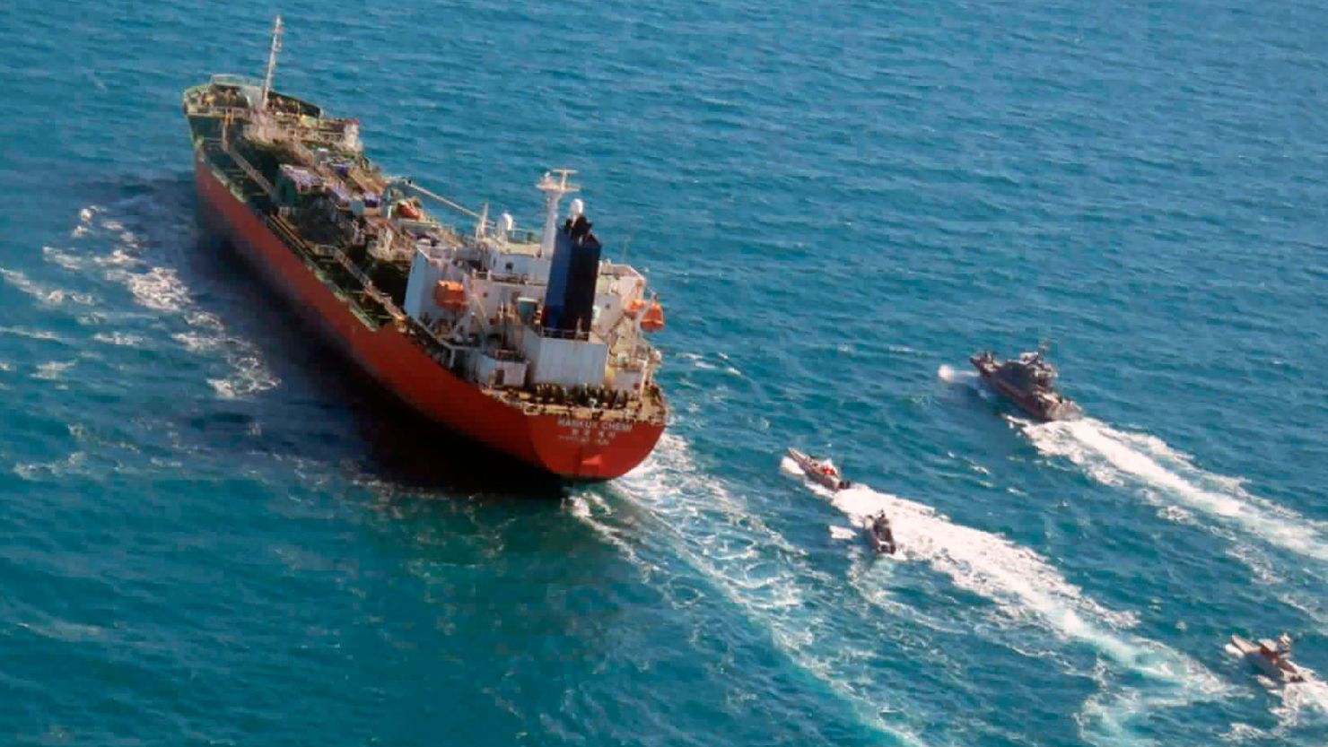 In this January 4, 2021 file photo released by Tasnim News Agency, a seized South Korean-flagged tanker is escorted by Iranian Revolutionary Guard boats on the Persian Gulf.