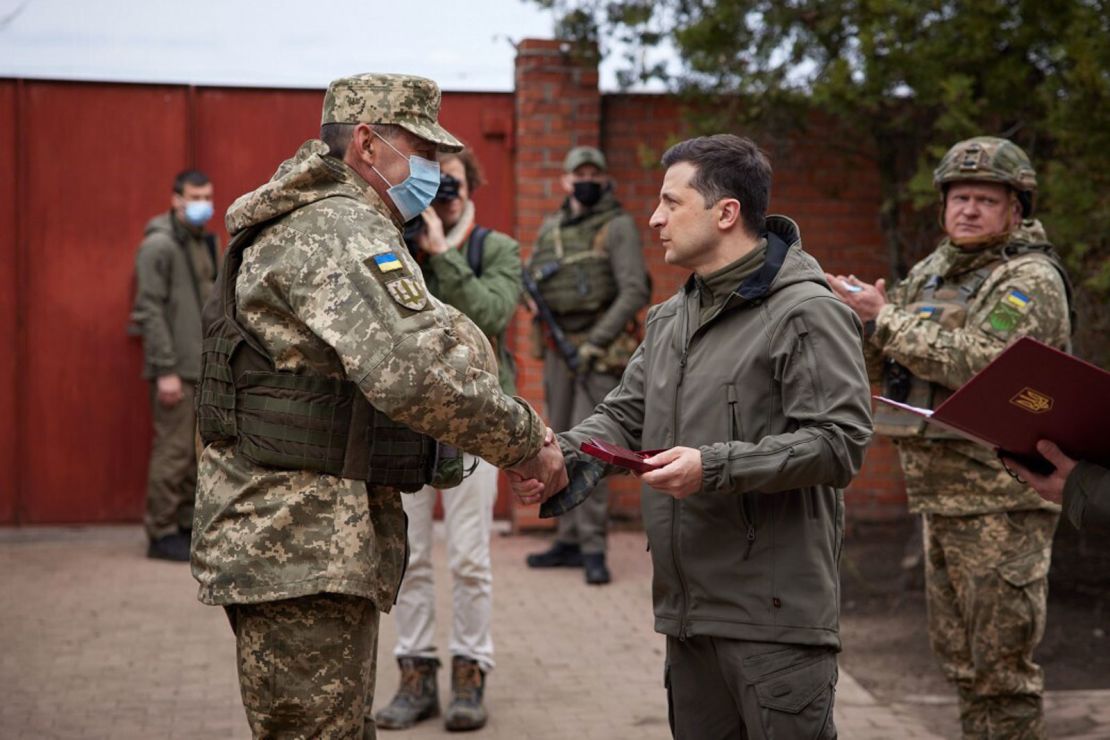Ukrainian President Volodymyr Zelensky (right) handshakes with a soldier during his visit to a front in Donbas, Ukraine on April 08.
