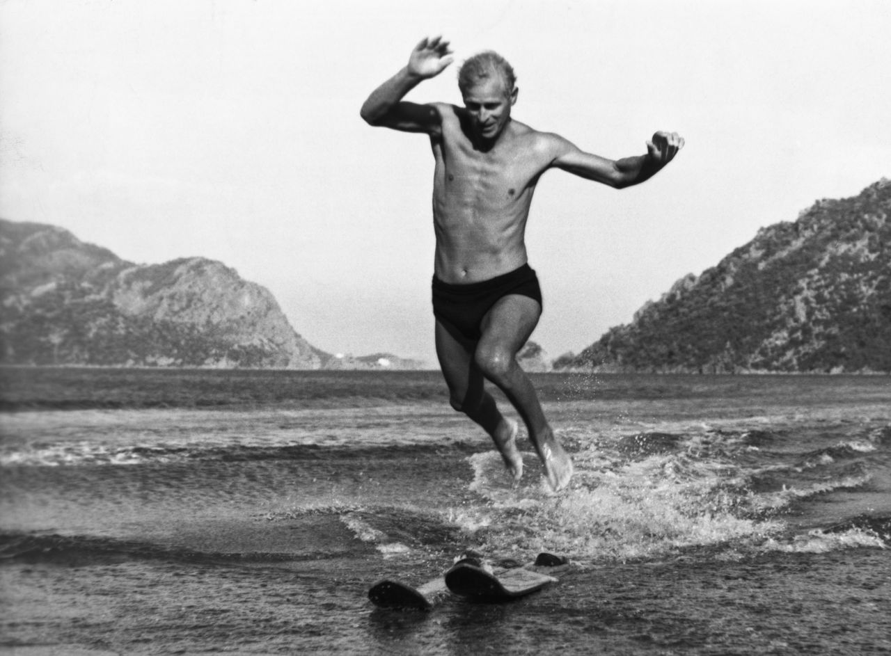 Prince Philip jumps off water skis on a beach in Marmaris, Turkey, in 1951. The photo was taken during his last posting as commander of the HMS Magpie, a Royal Navy ship.