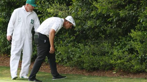 Bryson DeChambeau hunts for his ball at the fourth hole.