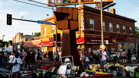 A sculpture of a raised fist stands in a memorial for George Floyd outside Cup Foods.