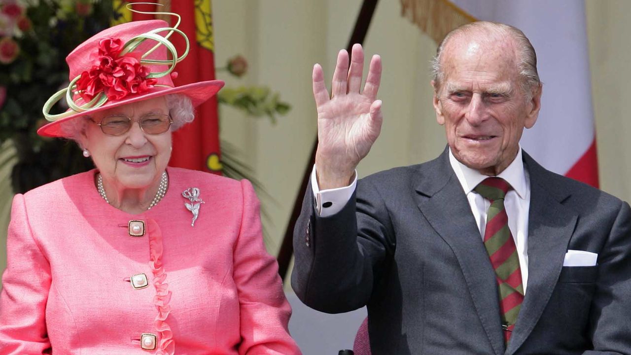 Queen Elizabeth and Prince Philip watch a Diamond Jubilee Pageant during a visit to RAF Cosford in Wolverhampton, England, as part of the Queen's Jubilee Tour of the UK, in July 2012.