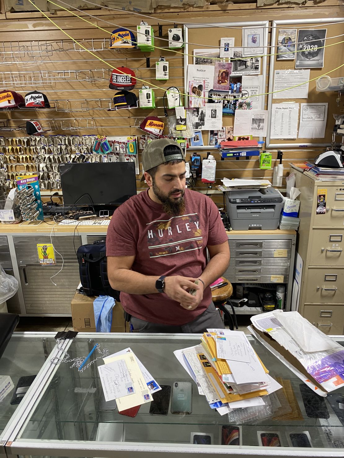 Cup Foods co-owner Mahmoud Abumayyaleh works behind the counter of his store.