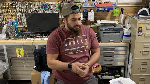 Cup Foods co-owner Mahmoud Abumayyaleh works behind the counter of his store.