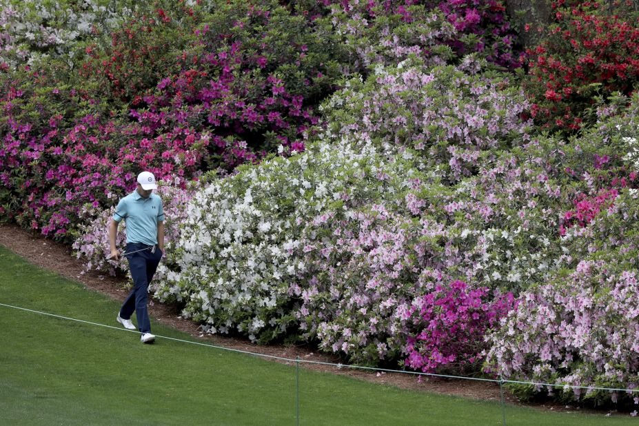 Former Masters champion Jordan Spieth walks past the azaleas on the sixth fairway Friday.