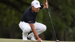 AUGUSTA, GEORGIA - APRIL 09: Si Woo Kim of South Korea lines up his putt with his 3-wood on the 18th green during the second round of the Masters at Augusta National Golf Club on April 09, 2021 in Augusta, Georgia. (Photo by Kevin C. Cox/Getty Images)