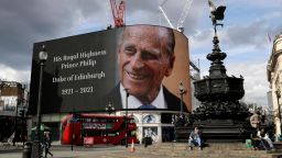 A tribute to Britain's Prince Philip is projected onto a large screen at Piccadilly Circus in London, Friday, April 9, 2021. Buckingham Palace officials say Prince Philip, the husband of Queen Elizabeth II, has died. He was 99. Philip spent a month in hospital earlier this year before being released on March 16 to return to Windsor Castle. (AP Photo/Matt Dunham)