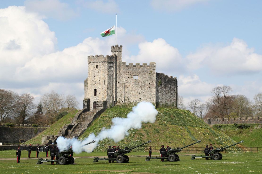 The gun salute is fired by the 104th Regiment Royal Artillery to mark the passing of Philip, the Duke of Edinburgh, at Cardiff Castle, in Wales on Saturday. 