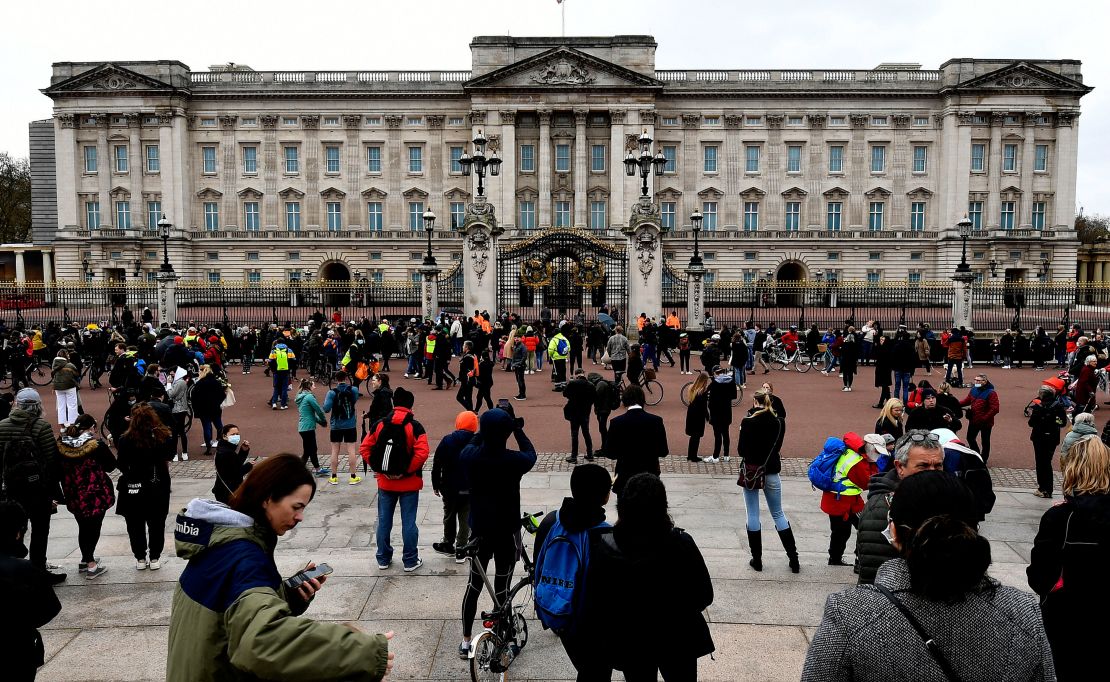 People gather outside the gates of Buckingham Palace in London on Saturday.