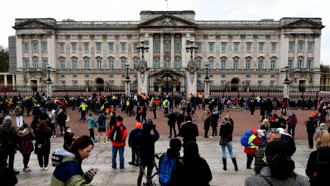 People gather outside the gates of Buckingham Palace in London on Saturday.