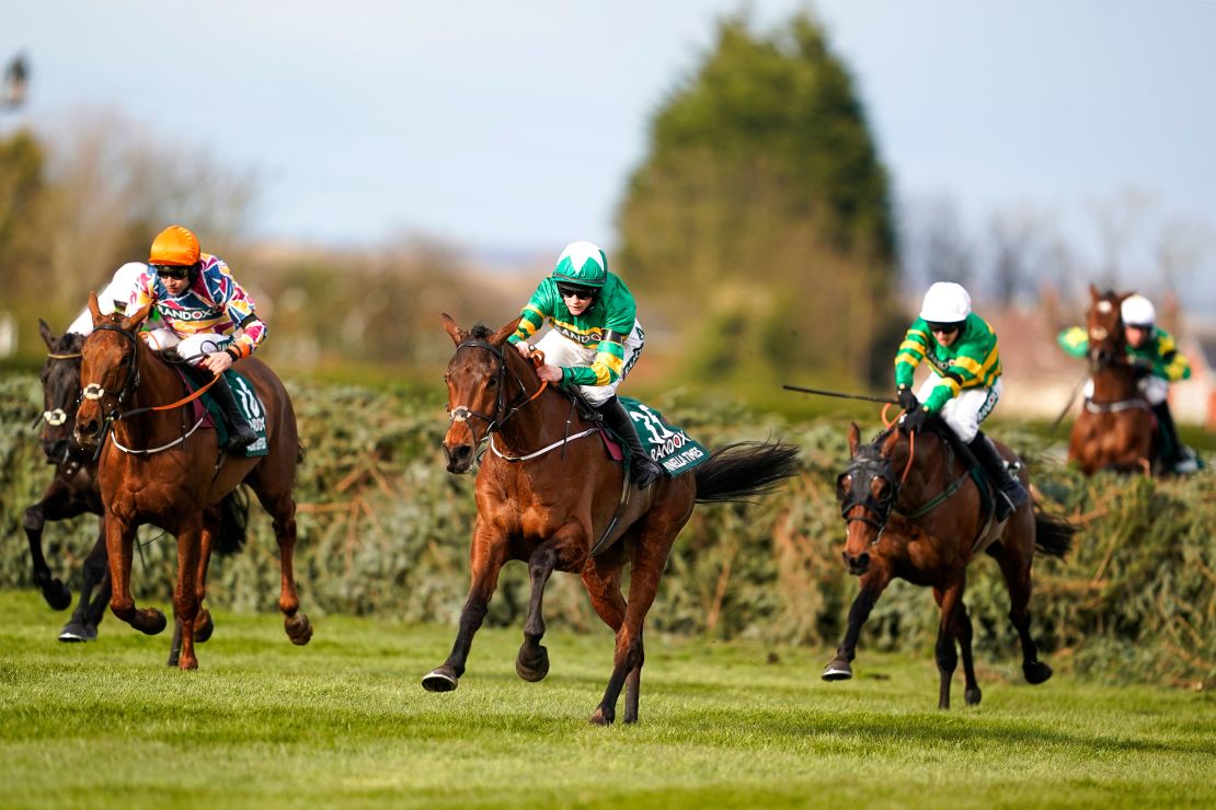 Blackmore riding Minella Times (middle) clears the last hurdle to win the Grand National. 