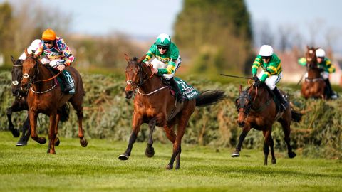 Blackmore riding Minella Times (middle) clears the last hurdle to win the Grand National. 