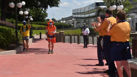 When he arrived at the park Disney security, cast members and guests cheered him on and loaded him down with a custom Mickey cap, balloons and more.